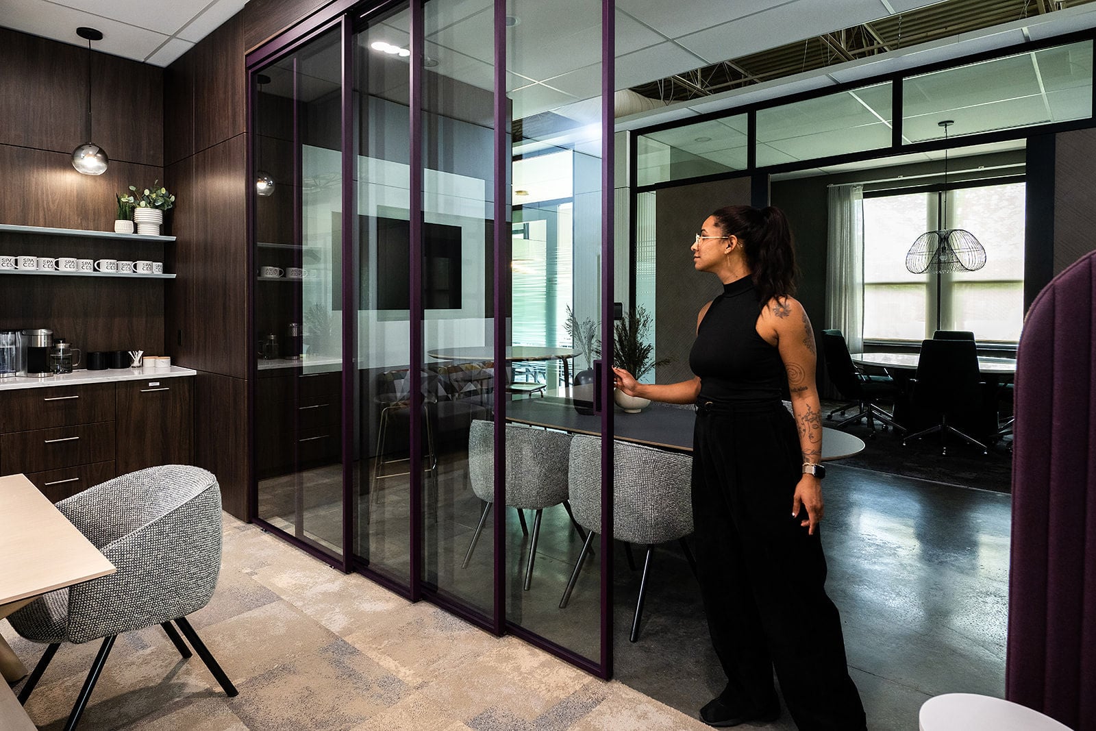 glass office walls - image of a woman looking at a glass office wall